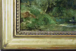 Close-up of the signature of Paul Désiré Trouillebert located in the lower left corner of his 19th-century river scene painting.